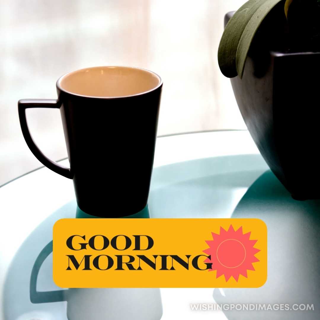 A cup of coffee in a black-colored cup on the table. Good Morning Coffee Images